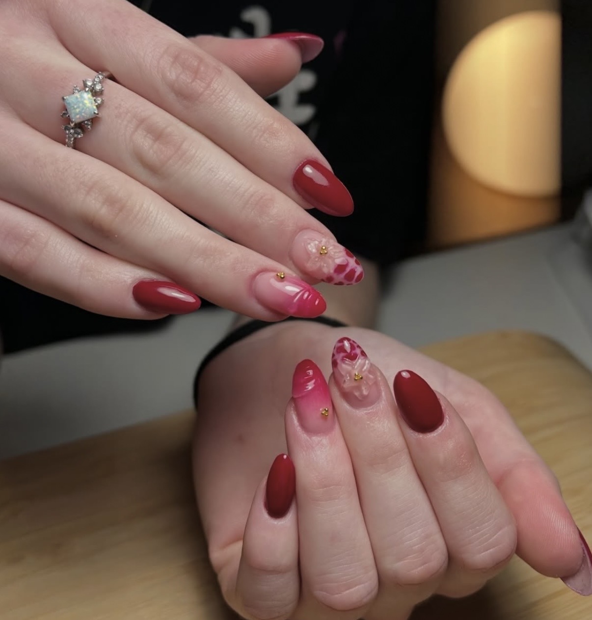 Red and pink almond nails with 3D flowers and gold beads
